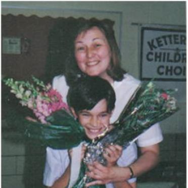 Valerie Bobosh with a young child and flower bouquets.