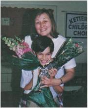 Valerie Bobosh with a young child and flower bouquets.